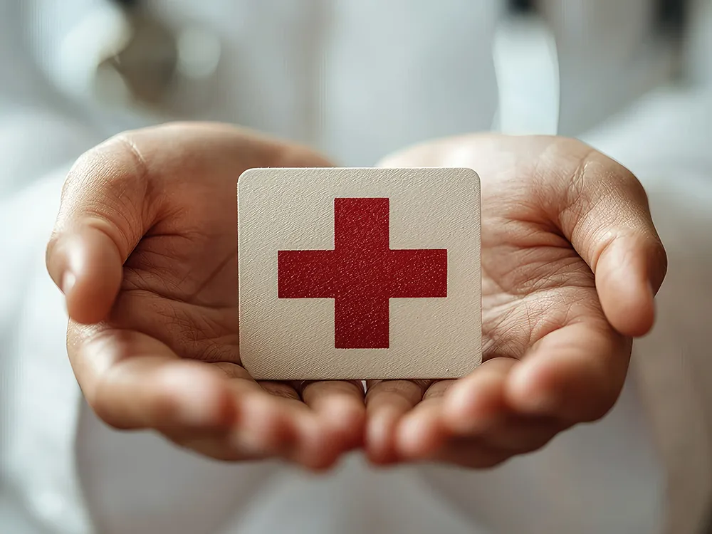 Man holding red cross for CPR Class Man holding red cross for CPR Class